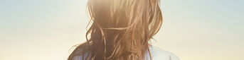 woman standing under the sun - L'Occitane
