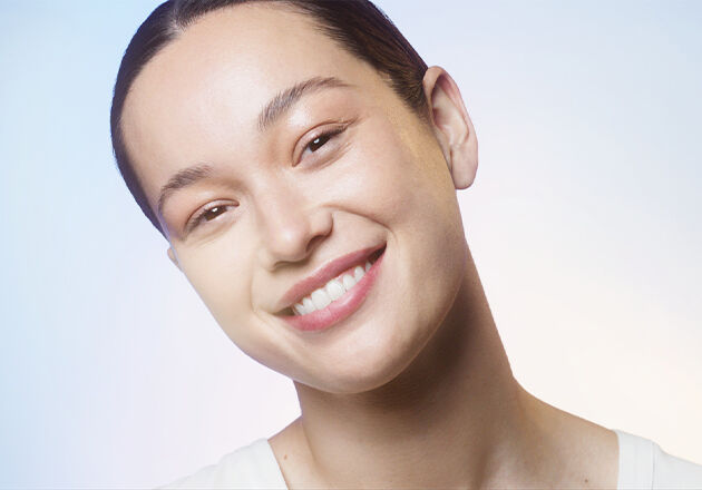 Woman smiling after application of essence.